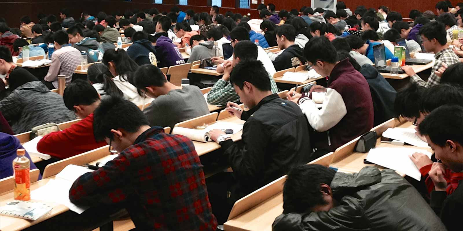 shows students at desks in a lecture hall